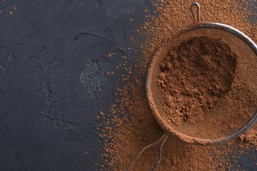 Sifted cocoa powder in a sieve