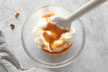 Combine caramel sauce and cream cheese frosting