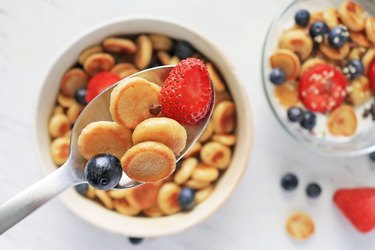Mini pancake cereal in bowl and spoon