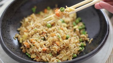 picking Japanese steakhouse fried rice up with chopsticks
