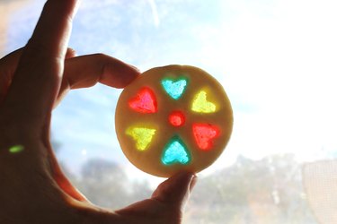 Sparkling stained-glass cookie held up to light