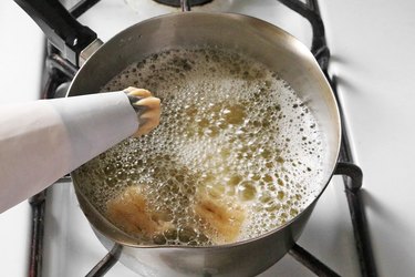 Pipe dough into hot oil