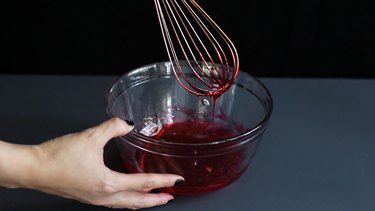 Whisking corn syrup and food coloring