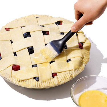 OXO Good Grips Silicone Baking and Pastry Brush Being Used to Apply an Egg Wash to a Pie