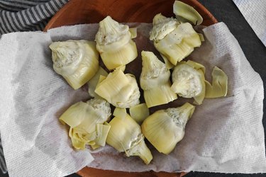 Squeeze the canned artichokes