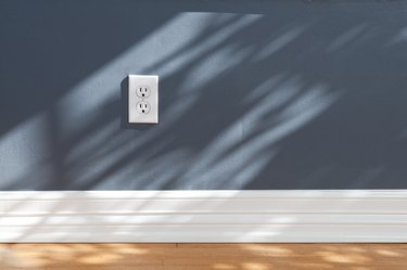 White baseboard with blue wall
