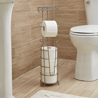 Freestanding toilet paper holder with storage and a shelf for a phone