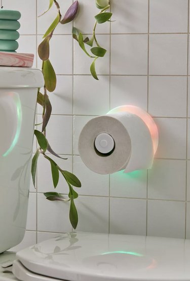 LED light up toilet paper holder mounted to bathroom wall