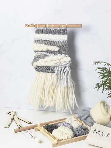 White and gray macrame hanging on white wall