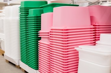 Food storage pans.folded colorful plastic containers in warehouse.Lot of empty plastic storage boxes stacked. Ready for home organizing sorting concept.