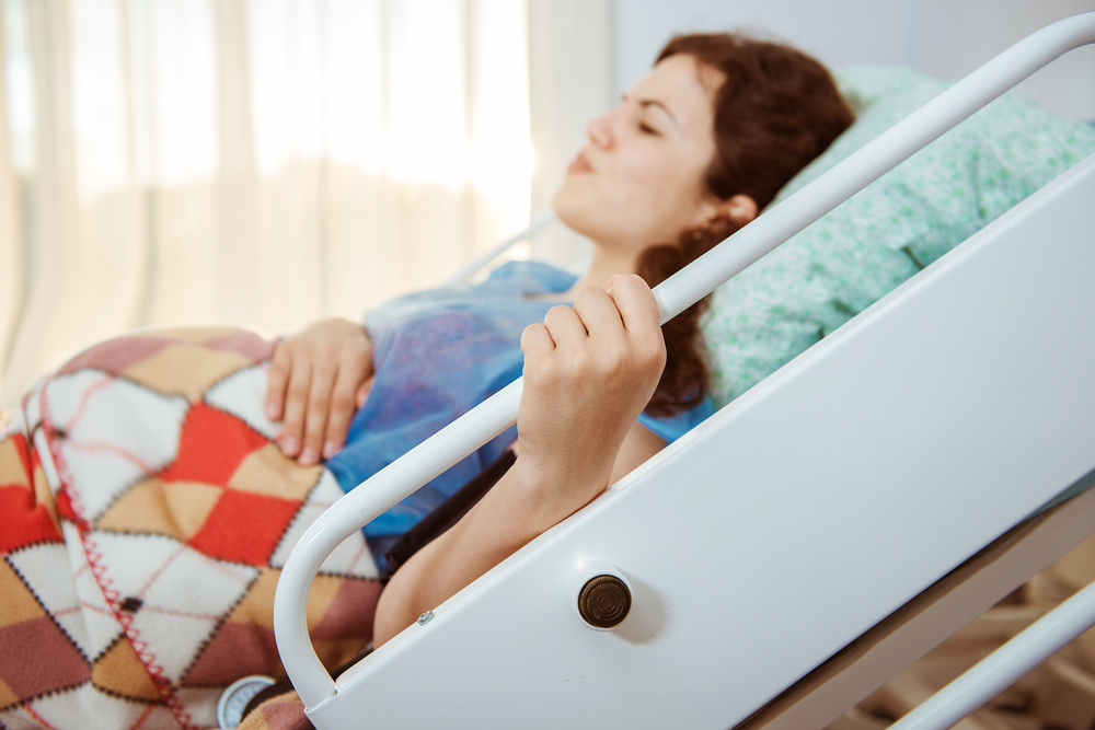woman in hospital bed giving birth
