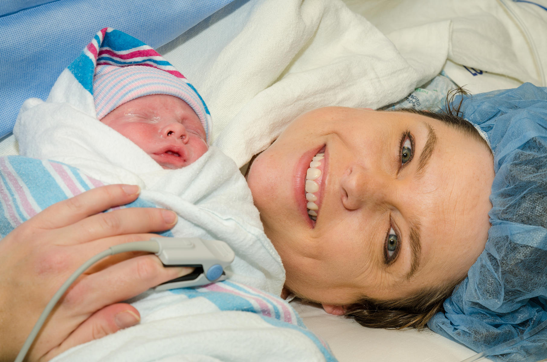 Mom holding baby after c-section or Cesarean birth.