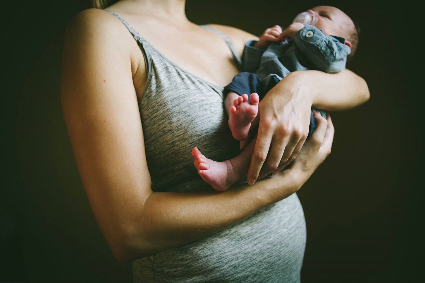 Postpartum body: new mom holding baby